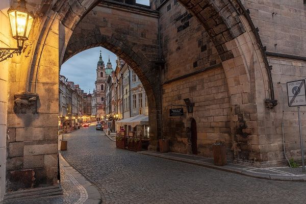 Arch of Lesser Town Bridge Tower on Charles Bridge with St Nicholas Church in Prague-Czech Republic